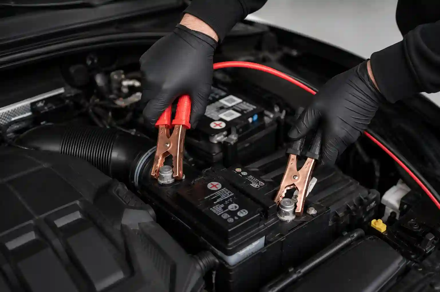 Vehicle battery being jump started in the workshop