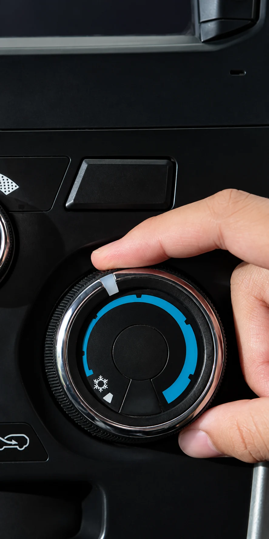 Hand turning a car air conditioning control dial