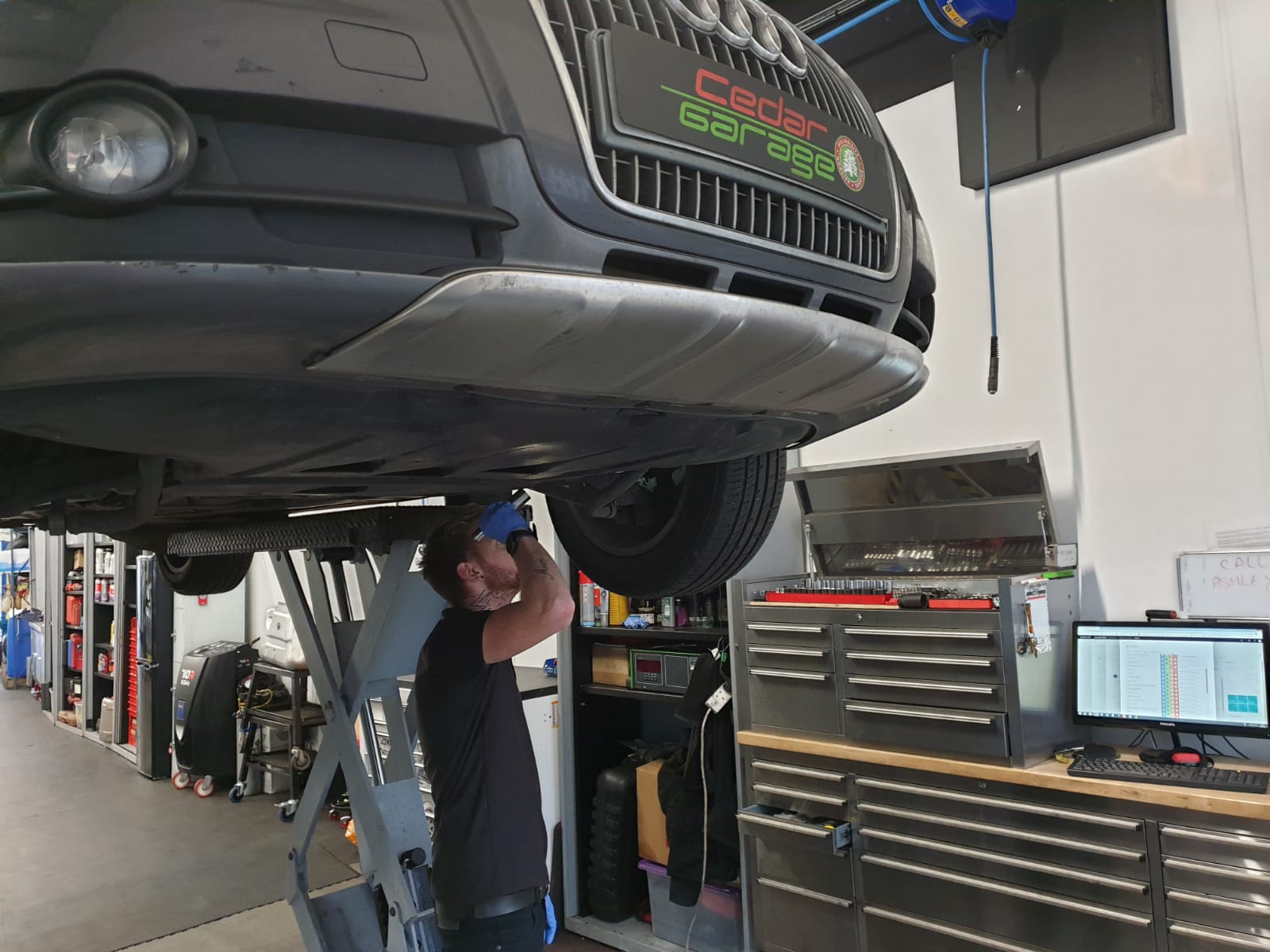 Technician servicing an Audi at Cedar Garage