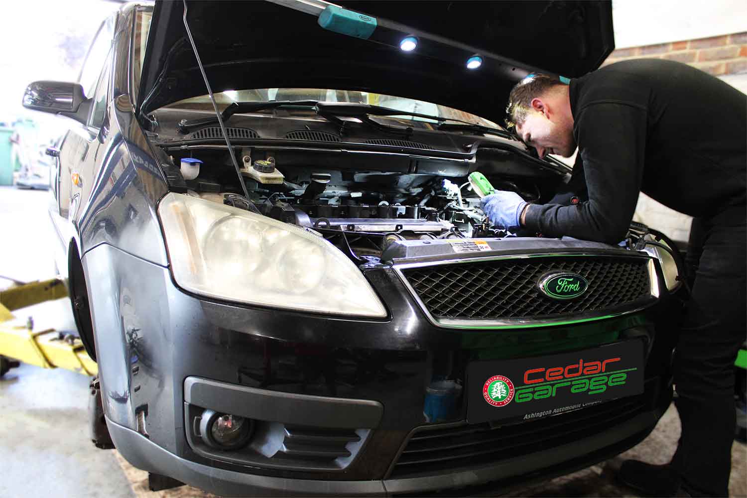 Technician working on a Ford at Cedar Garage