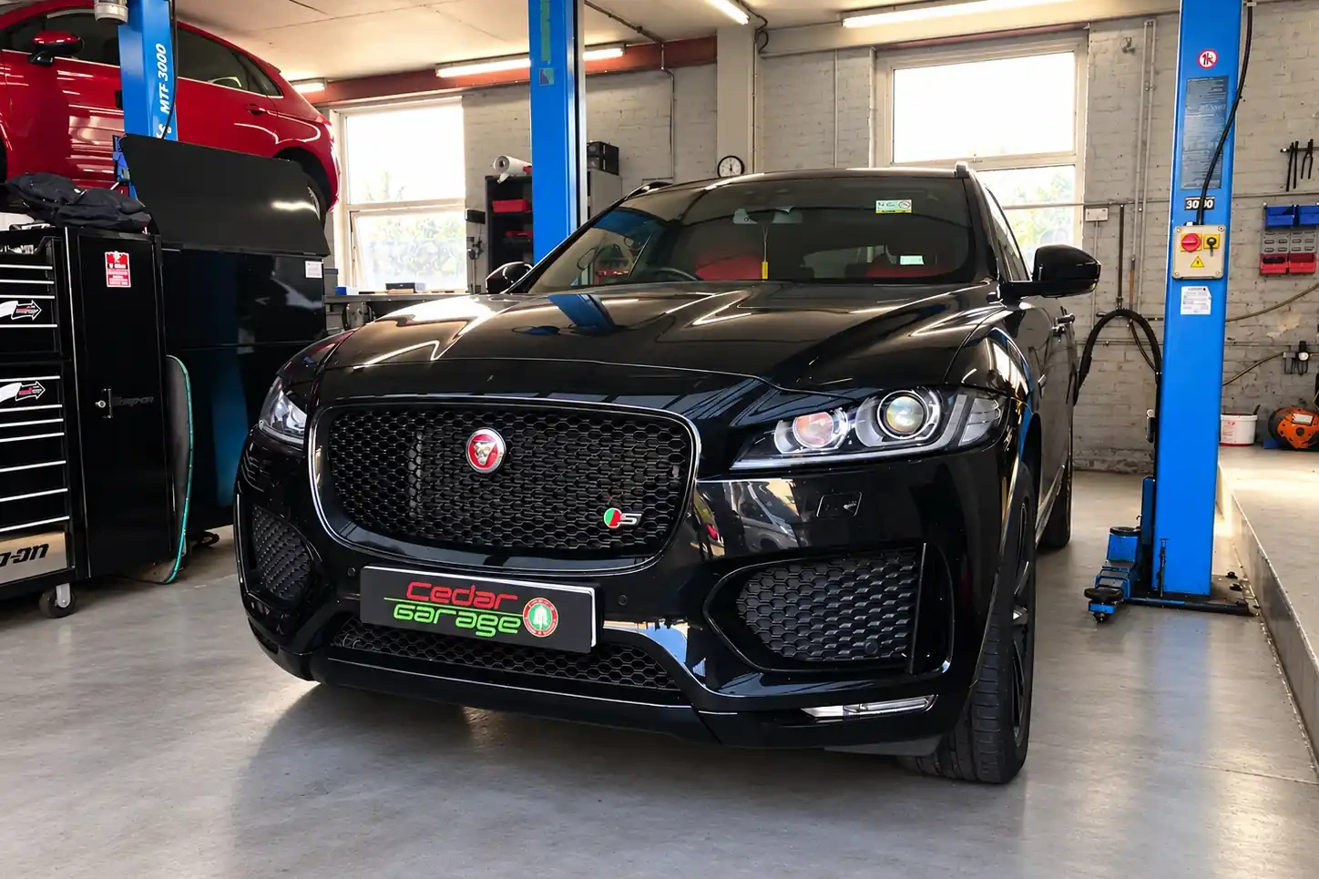 Jaguar Servicing and MOT Jaguar SUV on a ramp ready for its service and MOT