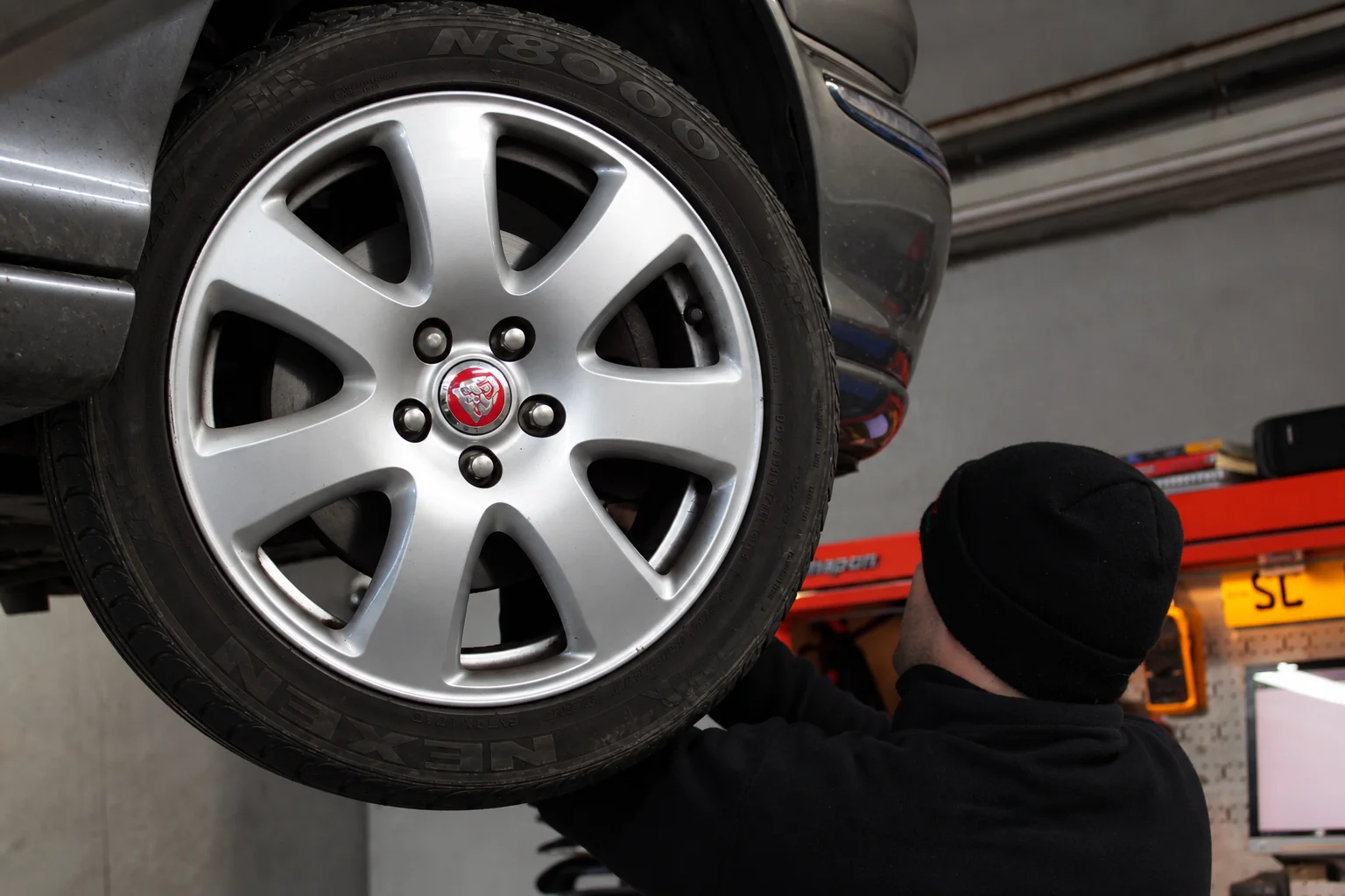 Jaguar Wheel Technician checking the wheel and tyre on a Jaguar