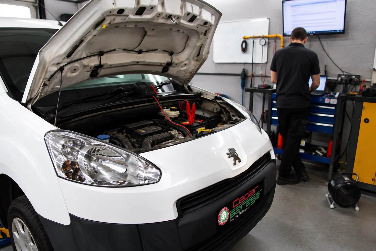 Peugeot Partner van connected to diagnostic equipment for fault finding at Cedar Garage