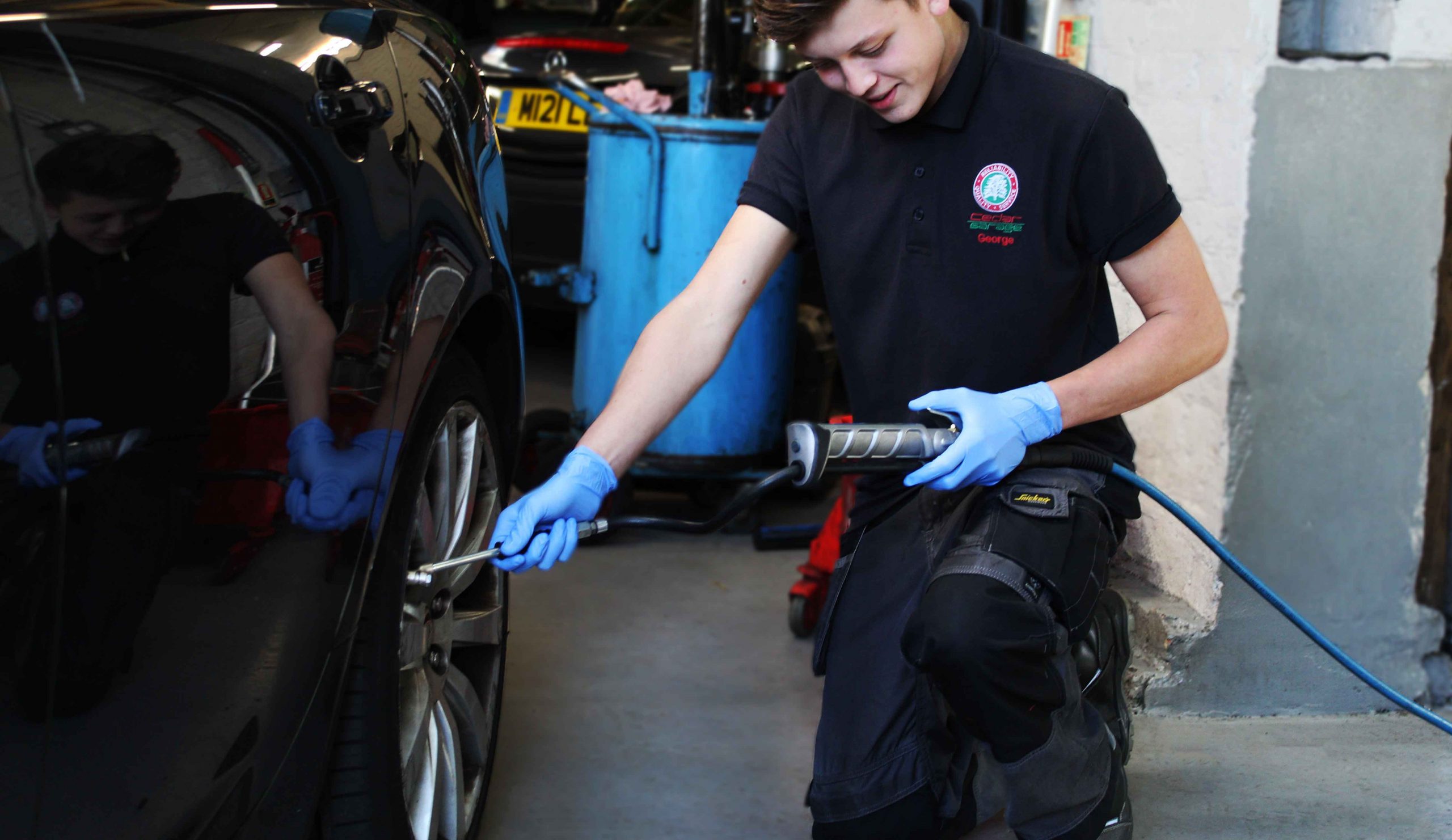 Cedar Garage Technician Performing a Service on a Jaguar