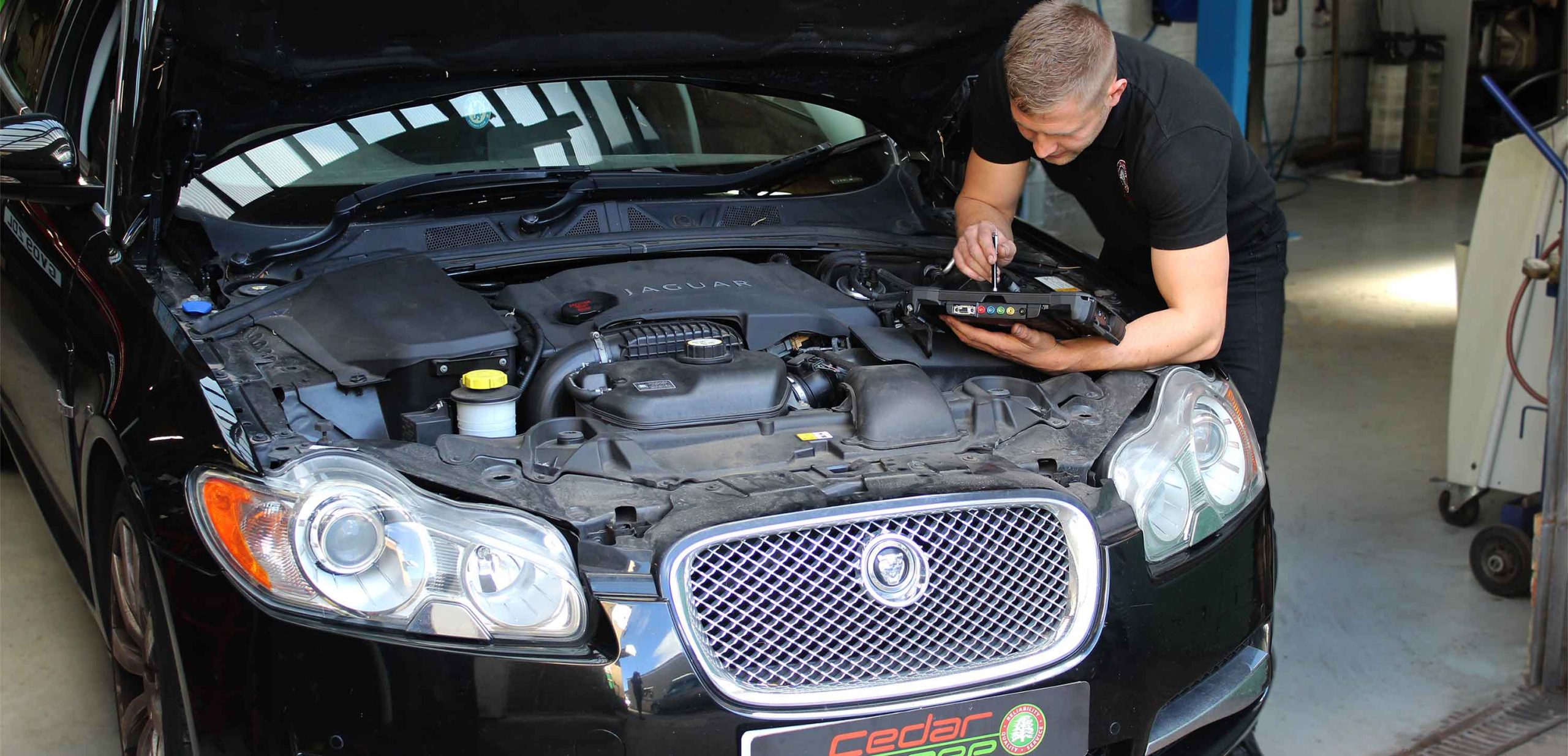 Diagnostic Technician Working on a Jaguar