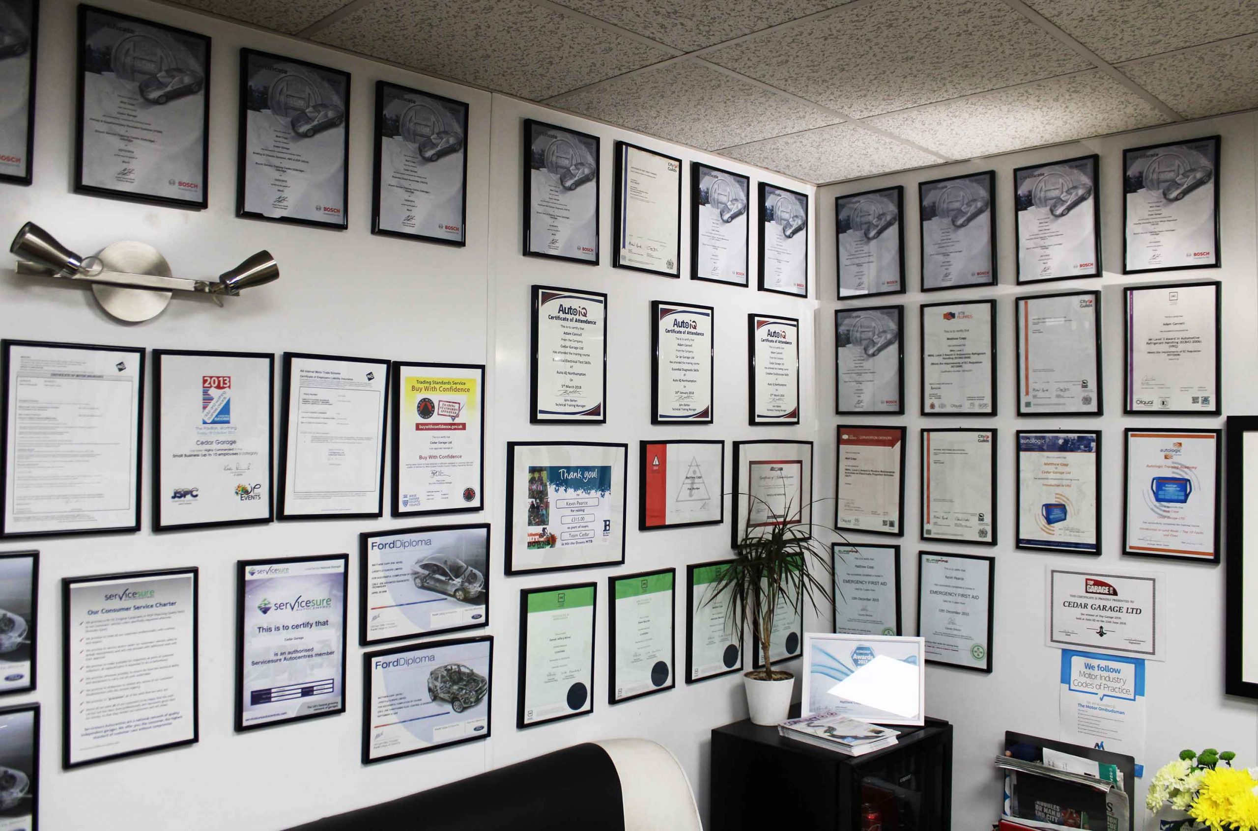 Technician certificates and awards on display in Cedar Garage reception