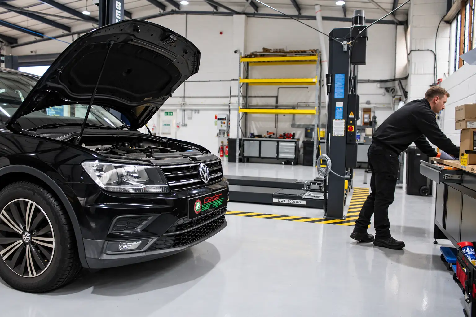 Technician carrying out vehicle fault finding on a Volkswagen Tiguan in the Cedar Garage workshop