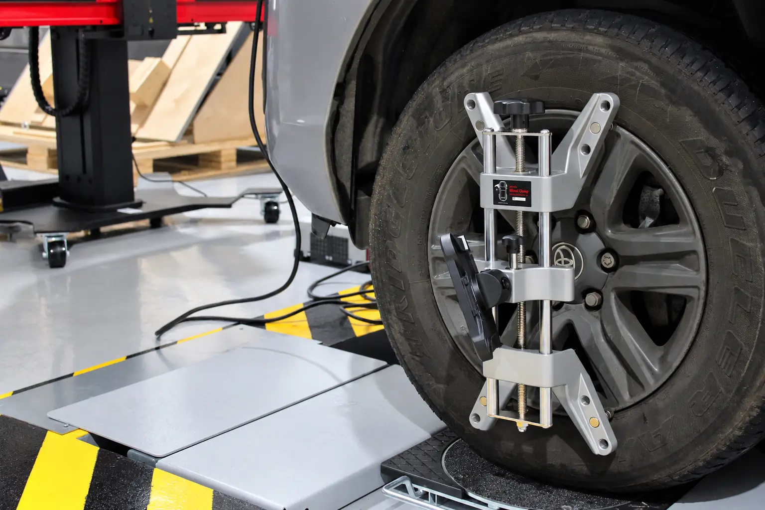 Wheel alignment clamp fitted to a car wheel at Cedar Garage